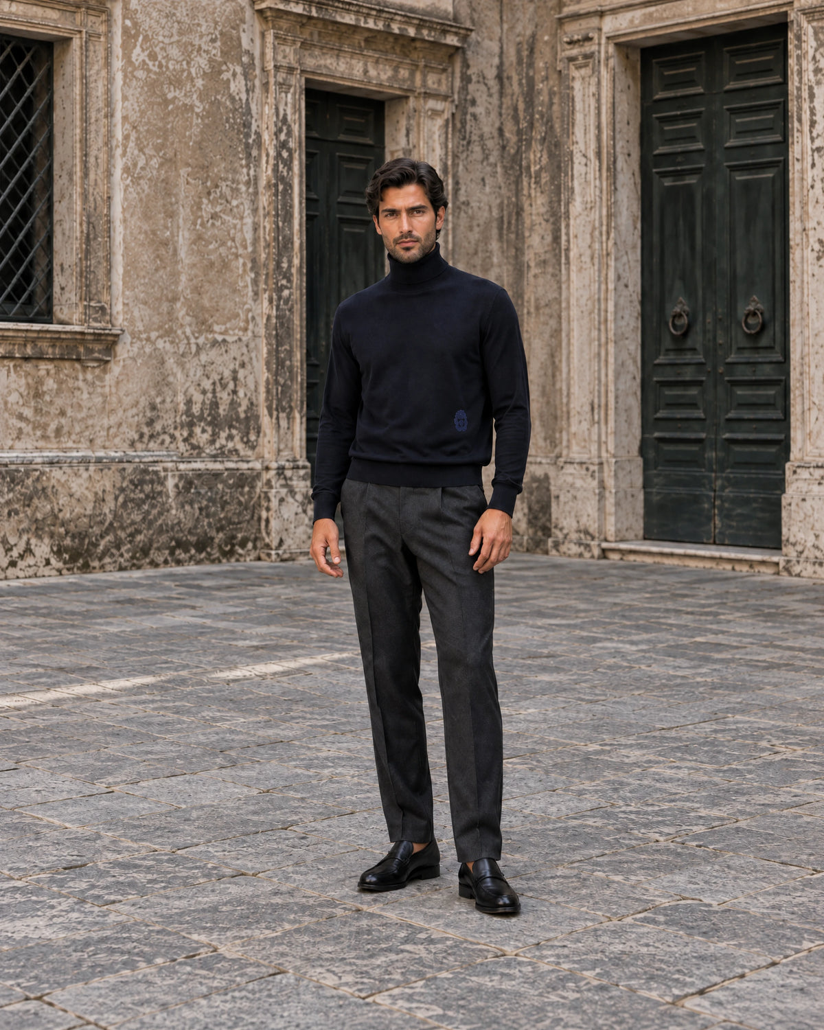 Autumn Italian knitwear editorial with a man in a navy turtleneck and tailored trousers