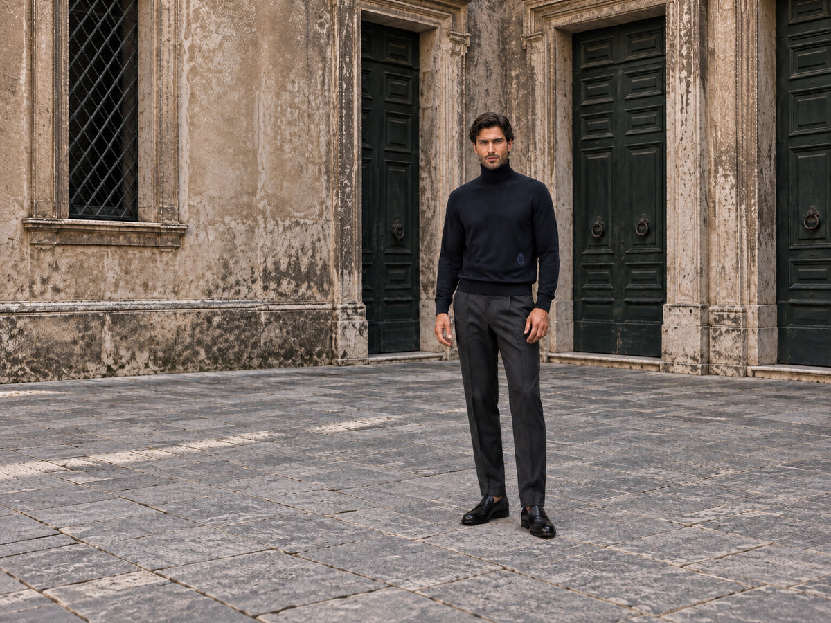 Autumn Italian knitwear editorial with a man in a navy turtleneck and tailored trousers