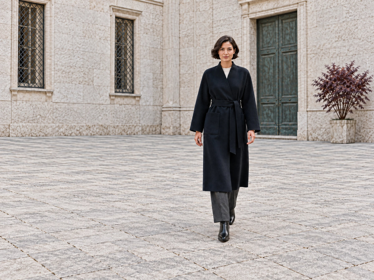 Autumn city editorial with a woman in a navy wrap coat and tailored trousers